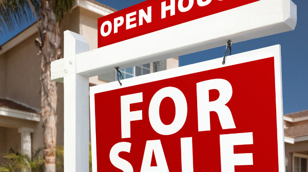 Image of a real estate for sale sign in front of a home